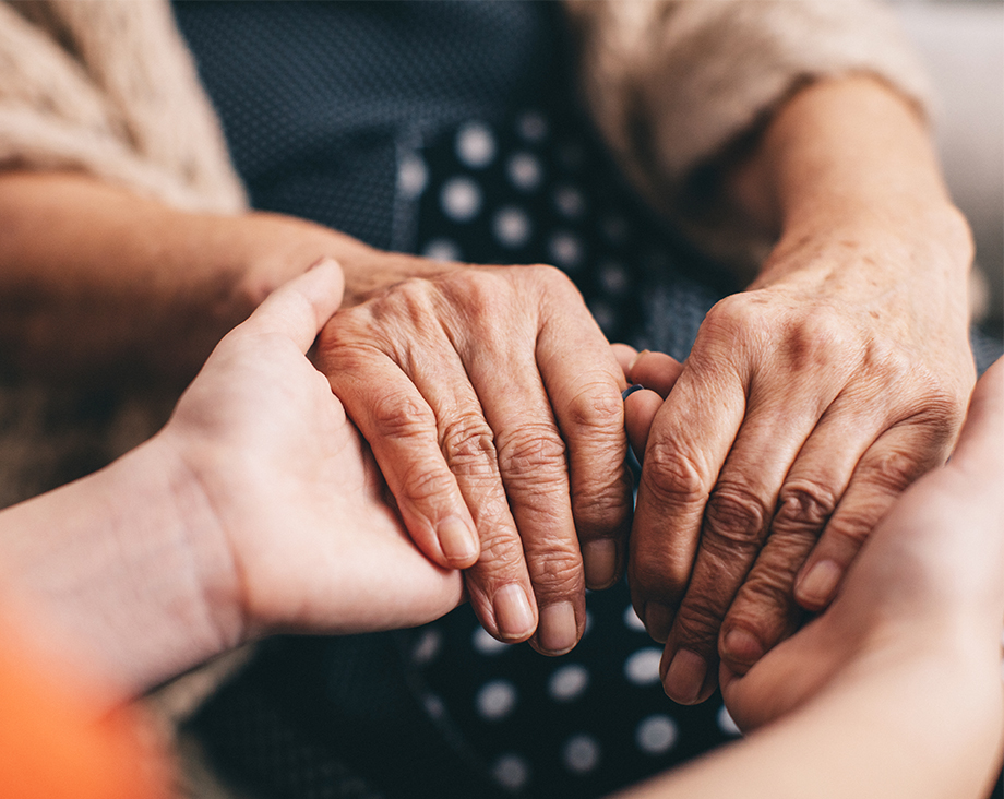 Two sets of hands holding each other