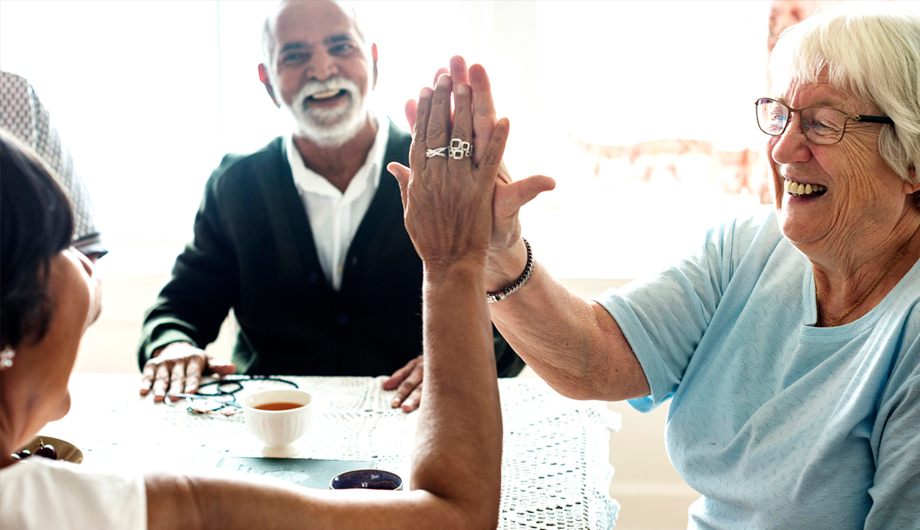 Two Older Smiling Women High Fiving