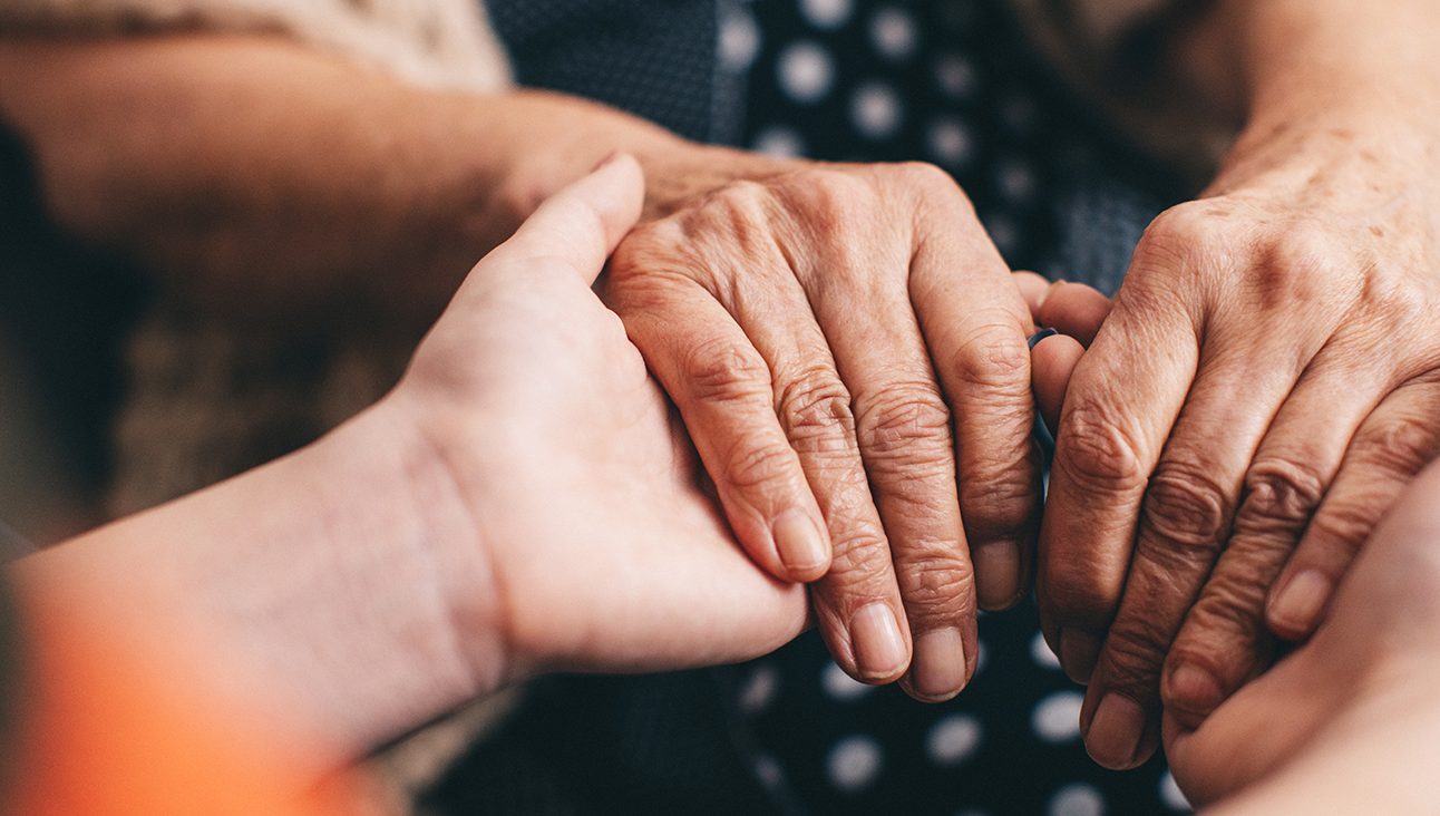 Two sets of hands holding each other