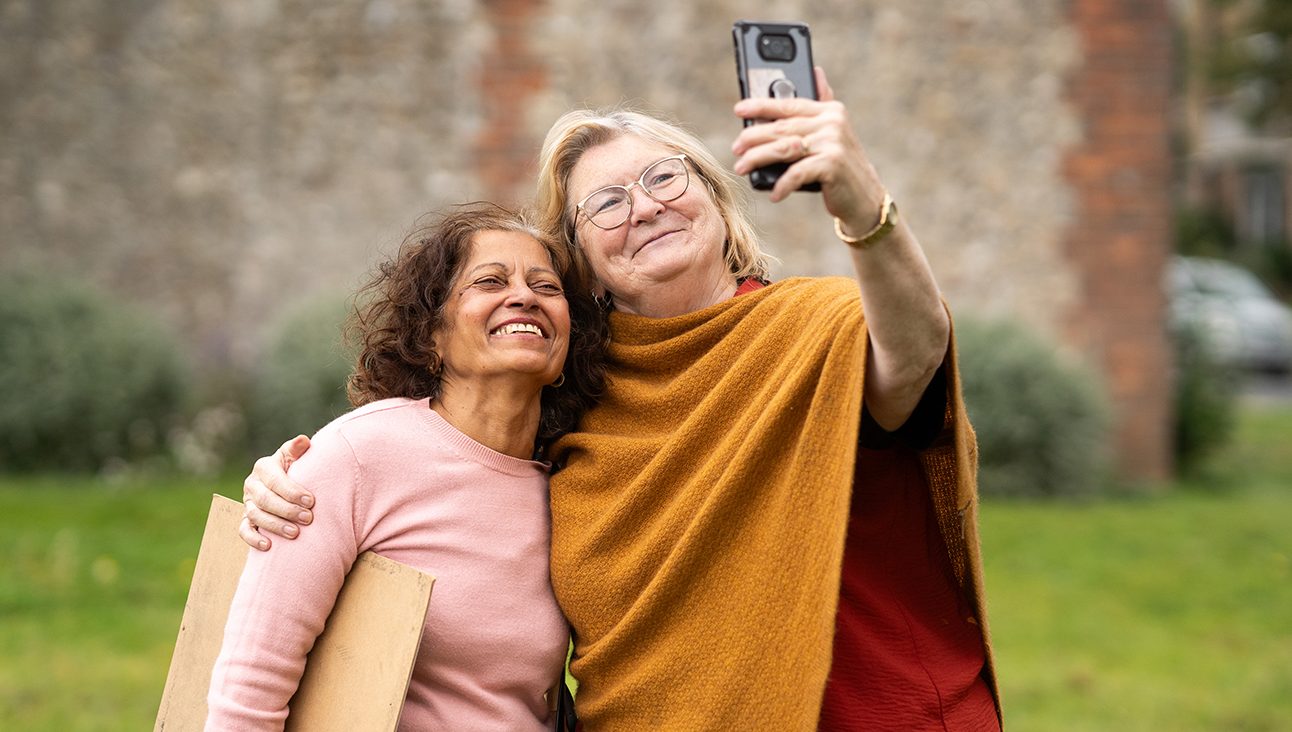 An South Asian woman and a white woman posing for a selfie
