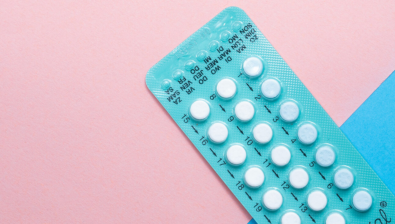 A set of birth control pills on a pink background